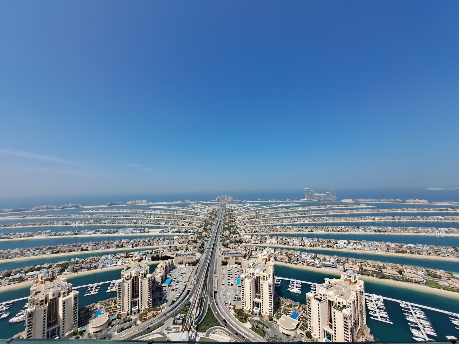 Aura Skypool Dubai — infinity pool deck high above the Palm at midday