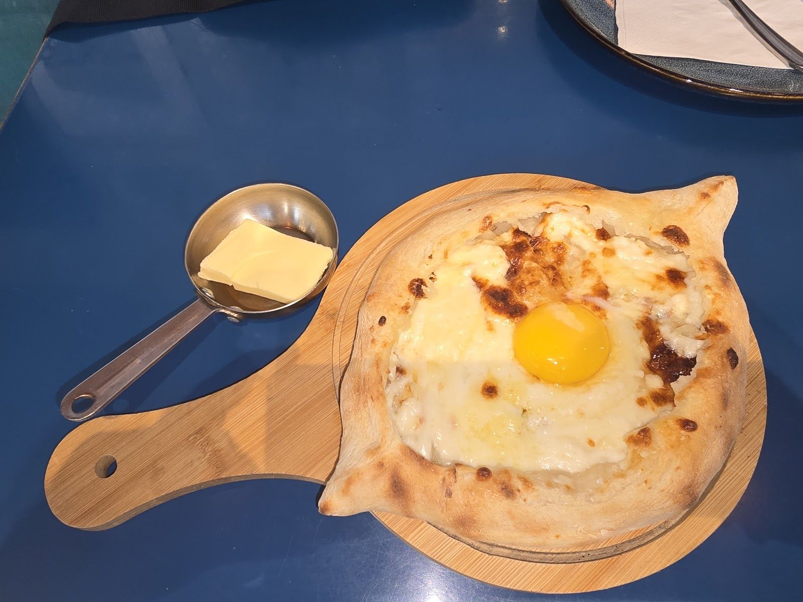 Adjaruli khachapuri boat shape with egg yolk and butter — Dubai