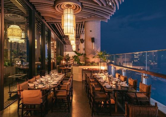 Mott 32 Dubai interior — dining room with Chinese art installations and dramatic lighting