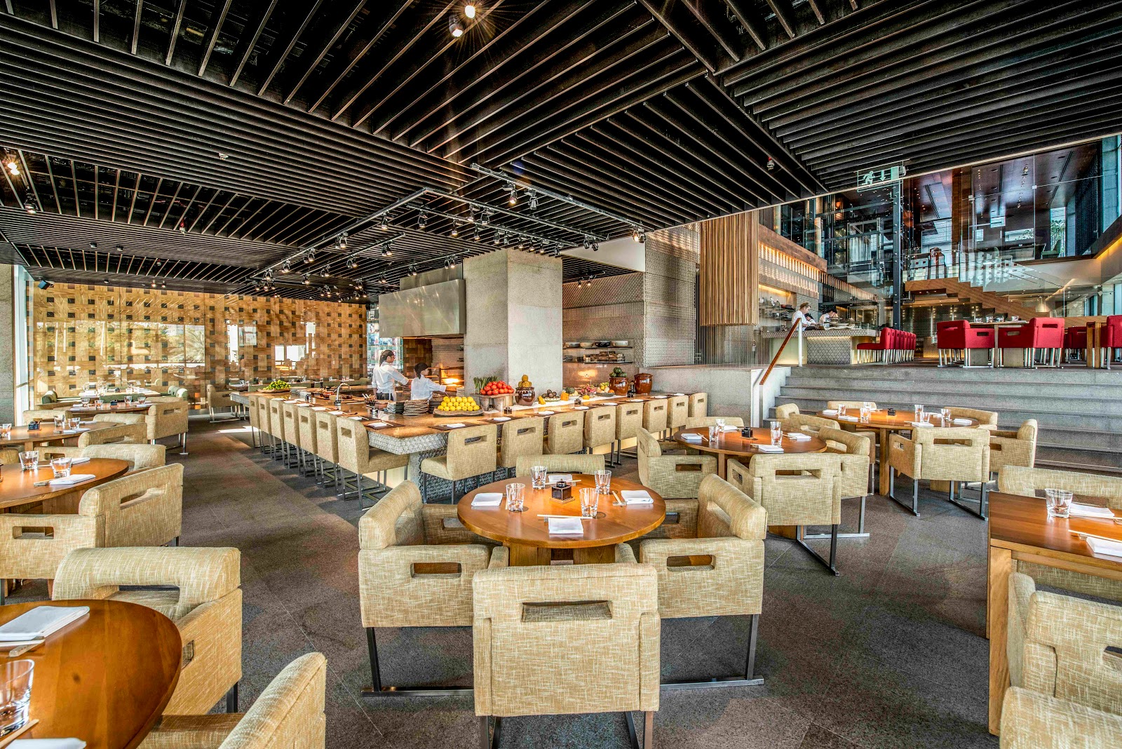 Zuma Dubai DIFC dining room — warm wood and central bar with robata grill